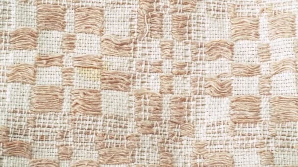 Dolly shot of beige textile. Texture of fabric, close shot. Beige towel, abstract background. Selective soft focus. Blurred background. — Stock Video