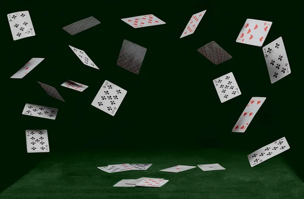 Playing cards fall on a green table — Stock Photo, Image