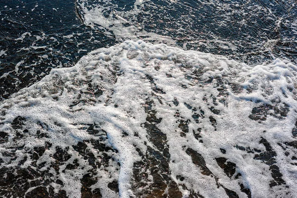Texture. Sea small wave with foam