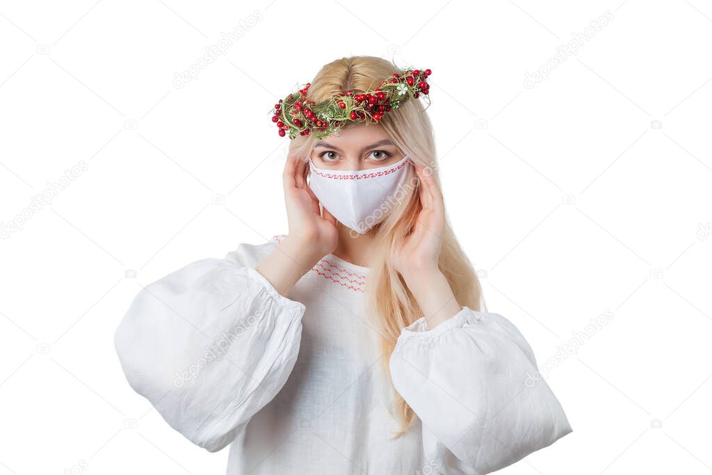 Young blonde girl in the mask in dress of folksy cut