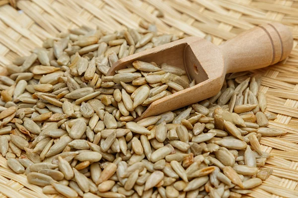 Peeled sunflower seeds in wooden scoop — Stock Photo, Image