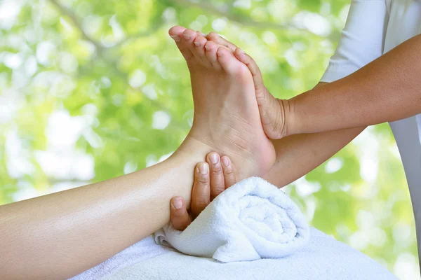 Masseur doing reflexology,Thai foot massage in spa on nature bac Stock Image