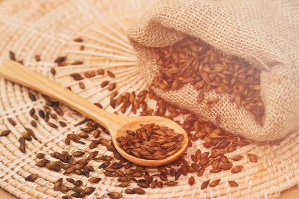 Roasted barley tea in the wooden spoon with solf blur filter — Stock Photo, Image