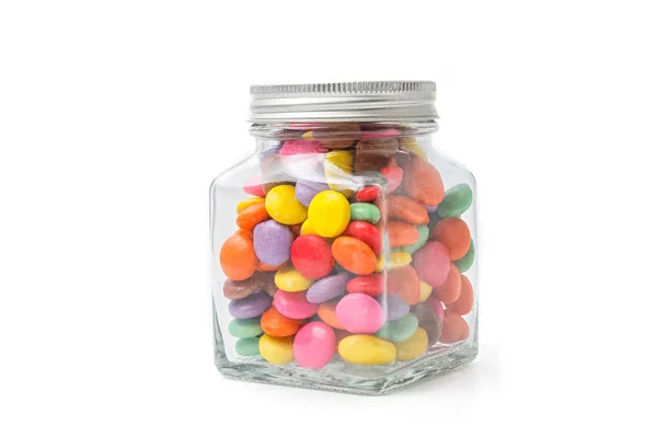 Kolorowe cukierki czekoladowe w szklanej butelce — Zdjęcie stockowe