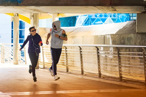Feliz esporte casal jogging juntos no ambiente da cidade — Fotografia de Stock
