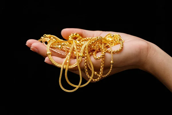 Hand Holding Expensive Gold Jewelry necklace and bracelet — Stock Photo, Image
