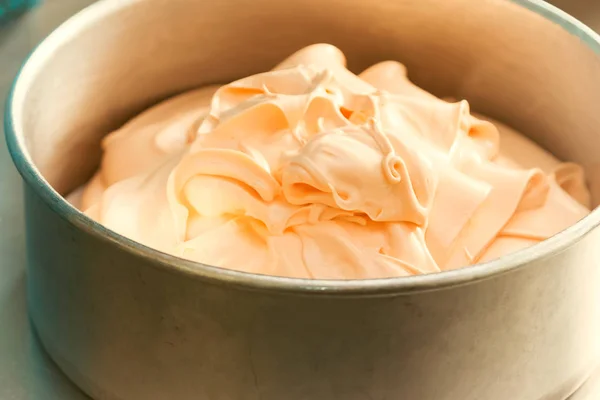Orange cream cake mixture in the baking tin — Stock Photo, Image