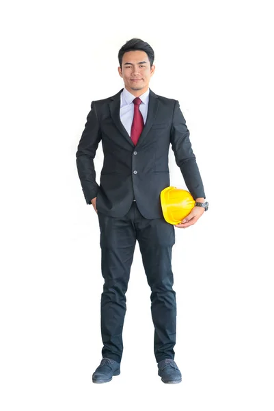 Podnikatel nebo technikem, který drží v ruce žlutou helmu pro pracovníky s — Stock fotografie