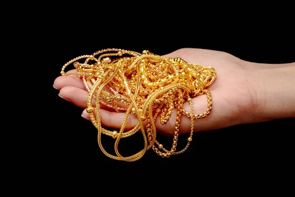 Main tenant cher bijoux en or collier et bracelet — Photo
