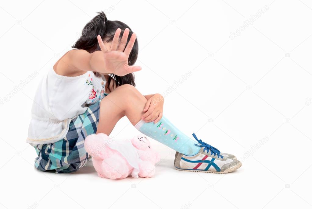 Scared little Asian girl making stop gesture with her hand