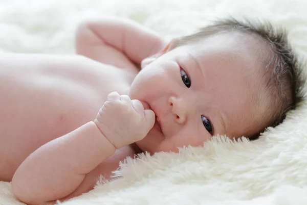 Newborn baby girl is sleeping on fur blanket — Stock Photo, Image