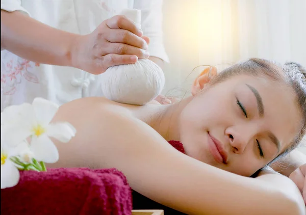 Woman getting thai herbal compress massage in spa — Stock Photo, Image