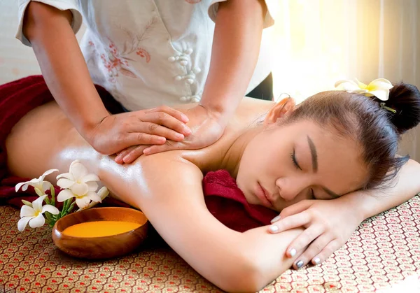 Woman getting thai herbal compress massage in spa — Stock Photo, Image