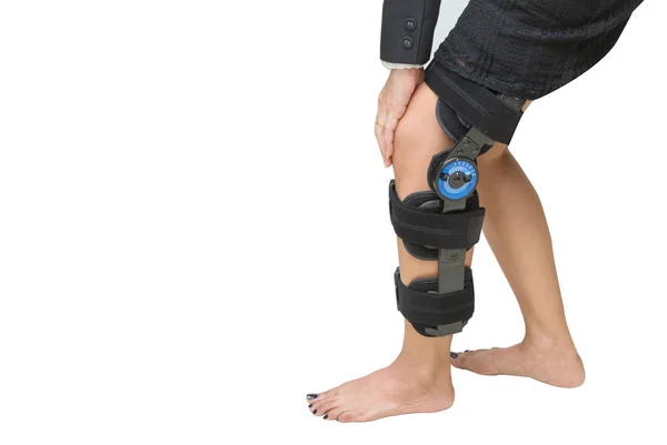 Knee support brace on patient leg isolate onwhite — Stock Photo, Image