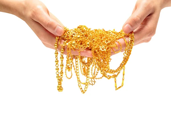 Ręka trzyma kosztowna biżuteria złota naszyjnik i bransoletka — Zdjęcie stockowe