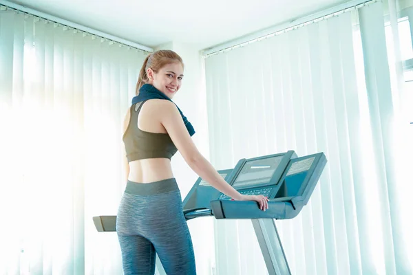 Happy cheerful athletes training on exercise bike. — Stock Photo, Image