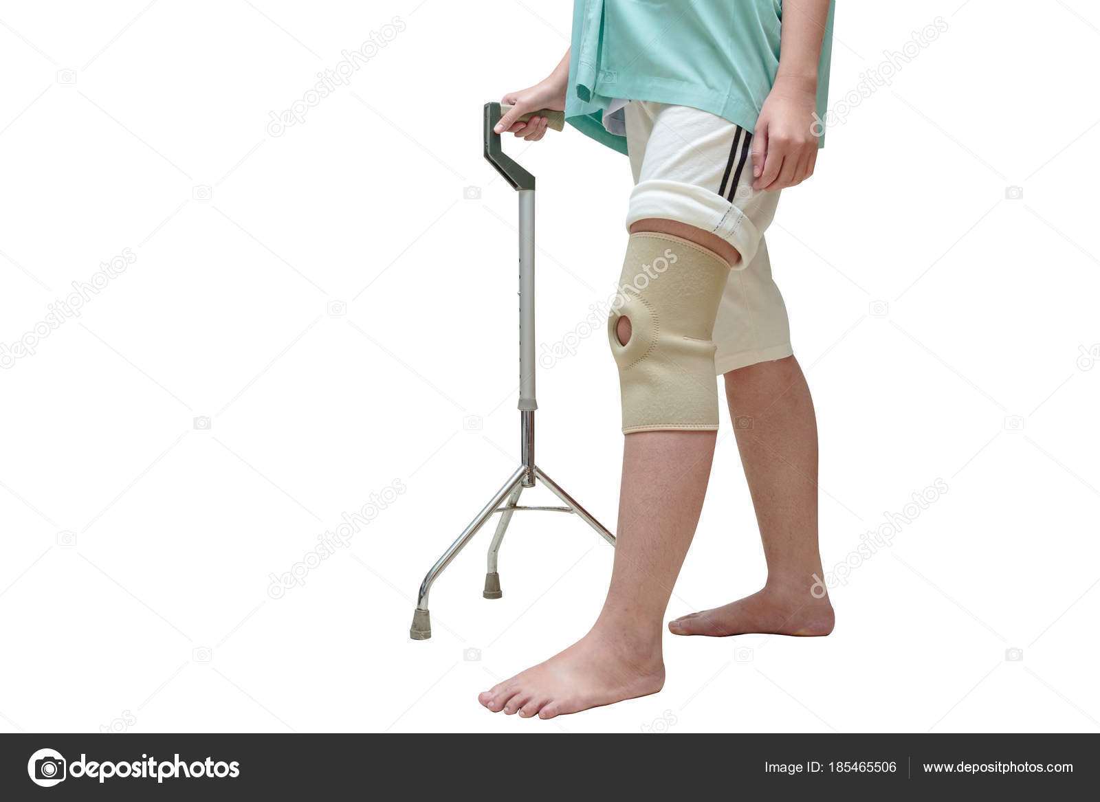 Woman in knee support walking on cane ,isolate on white Stock Photo by