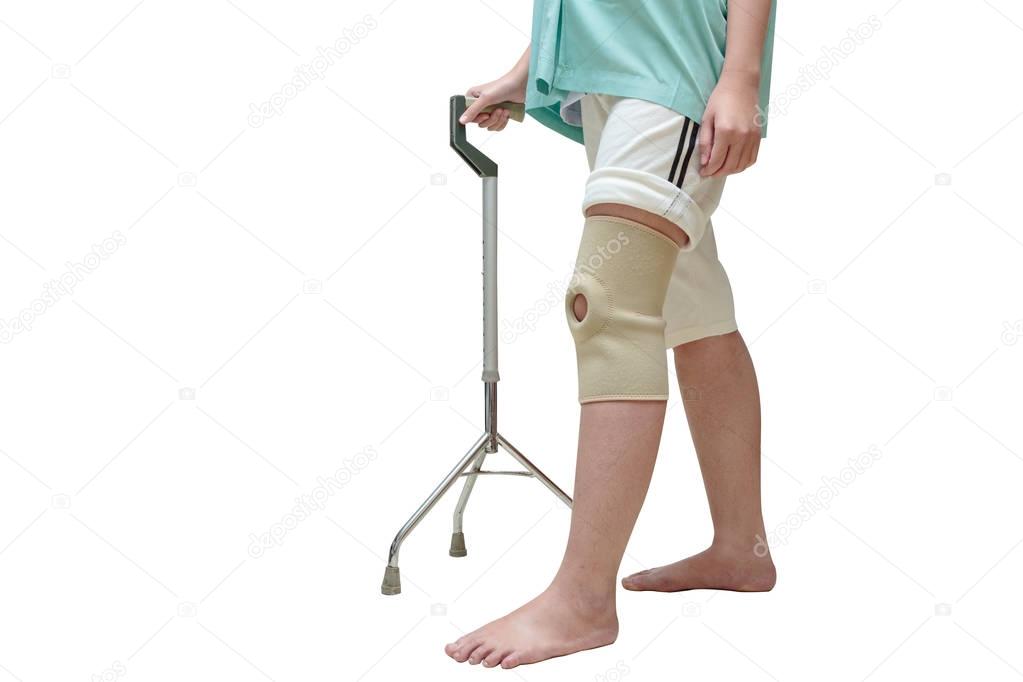 Woman in knee support walking on cane ,isolate on white