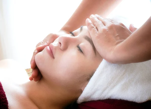 Closeup of young woman getting spa face massage at beauty salon. — Stock Photo, Image