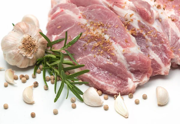 Raw pork meat steaks with spices on the white background. — Stock Photo, Image
