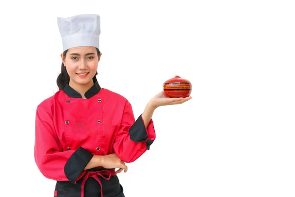 Usmívající se žena kuchař v červených uniformách drží kuchyňské náčiní — Stock fotografie