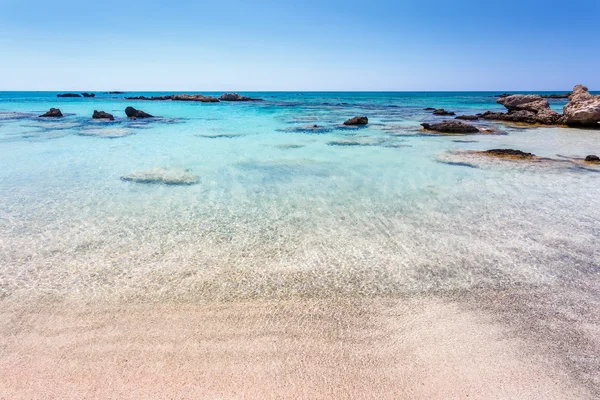 Rocks in the water near the shore at Elafonisi beach. Crete. Greece. — Stockfoto