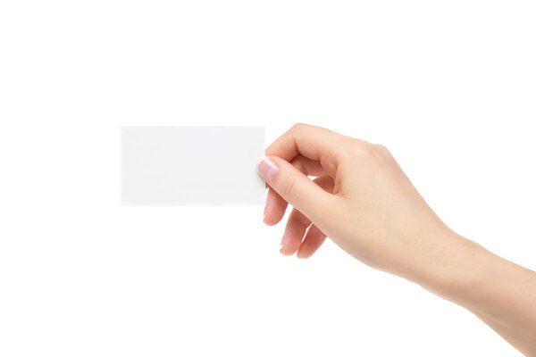 Female hand holds white card on a white background.