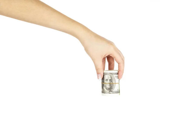 Женская рука со скрученной стопкой долларов на белом фоне . — стоковое фото