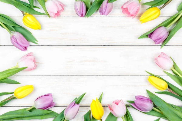 Tulipas rosa e amarela em um fundo de madeira branco — Fotografia de Stock