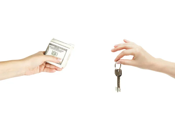 Händchenhalten mit Schlüsseln und einem Stapel Dollars auf weißem Hintergrund — Stockfoto