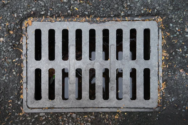 The metal cover for the drainage on the street