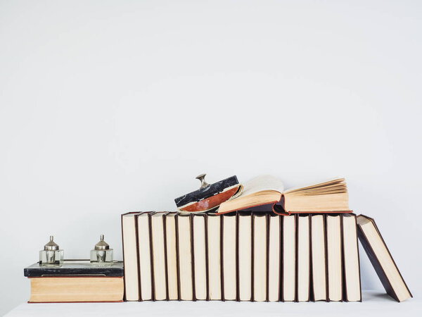 Vintage books with yellow pages on a white table