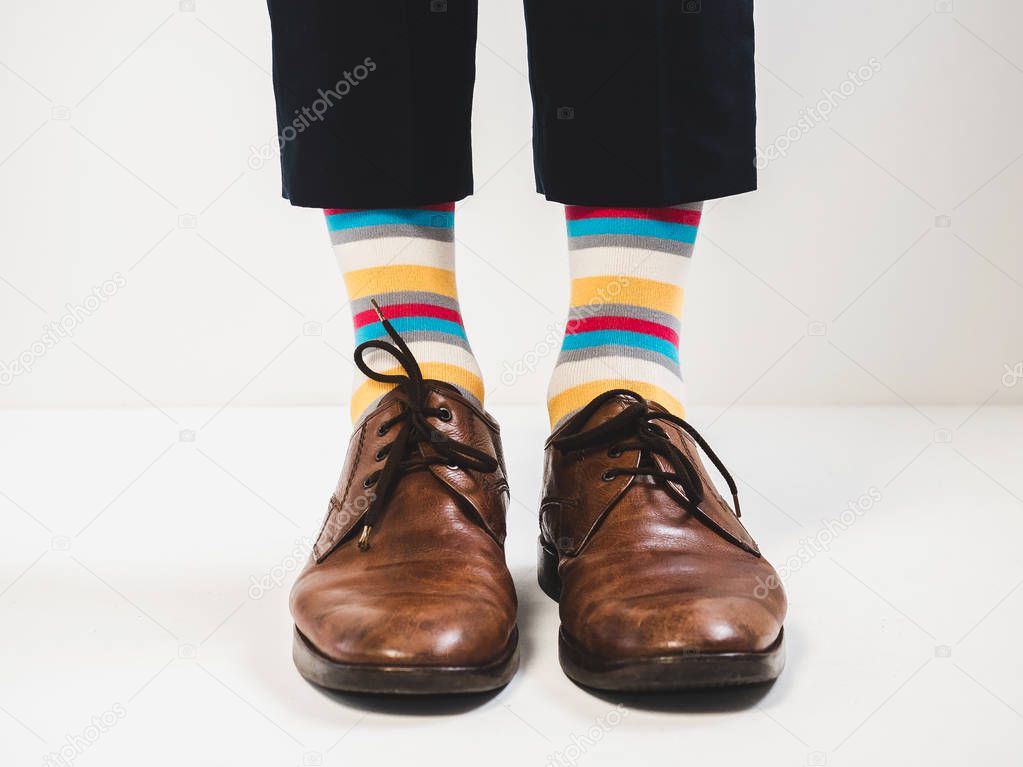 Men's feet in stylish shoes and bright socks