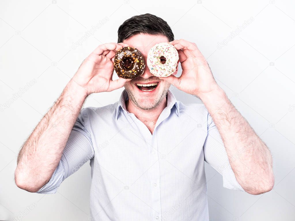 Funny guy holding colorful donuts