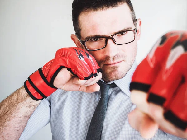 Businessman and red boxing gloves