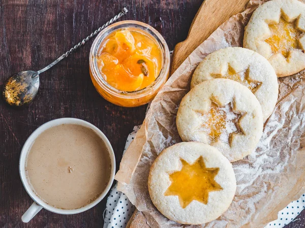 Fresh cookies and orange jam. Close-up, side view