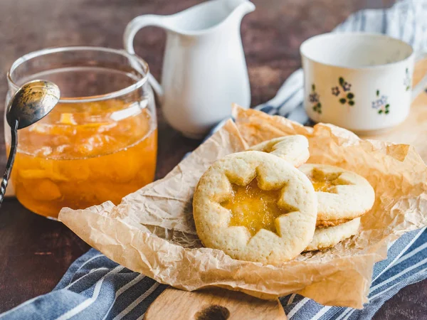 Fresh cookies and orange jam. Close-up, side view