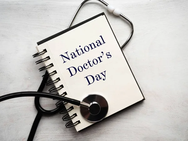 Happy national Doctor\'s Day. Beautiful card. Isolated background, wooden surface. Congratulations to family, relatives, friends and colleagues