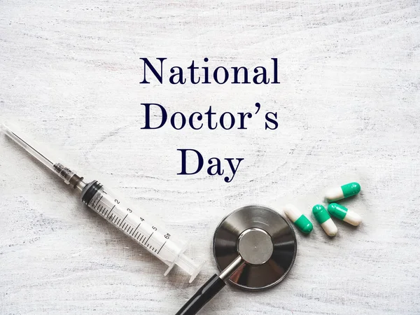 Happy national Doctor\'s Day. Beautiful card. Isolated background, wooden surface. Congratulations to family, relatives, friends and colleagues
