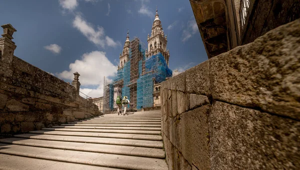 Galicia, the Cathedral of Santiago de Compostela. Pilgrims on the background of the cathedral The final destination of pilgrims.