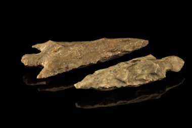 Two Indian arrowheads and black background clipart