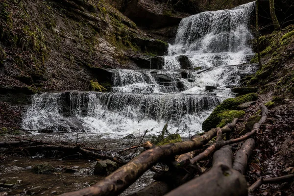 Little waterfall down the canyon in the middle of the green forest