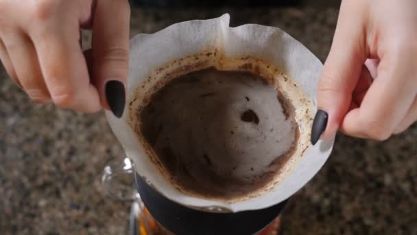 Modern and alternative ways of coffee making.Barista brews coffee using Coffee maker Chemeks. Close up of a barista making hand brewed coffee. Slow motion — Stock Video