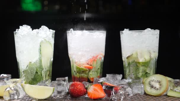 Bar and cocktail concept. Bartender prepare different Mojito Cocktails. Close up. Splashes. Slow motion. — Stock Video