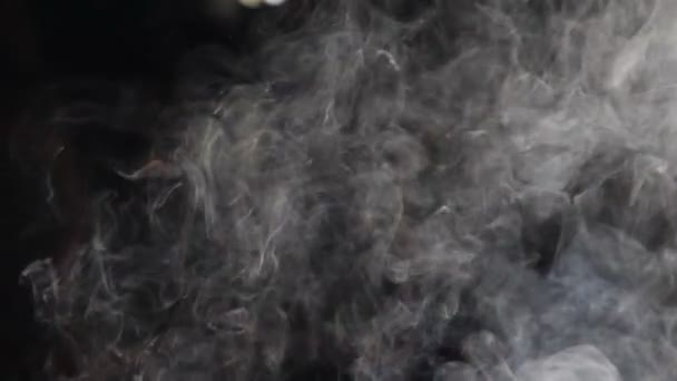 White Steam Ascends Over Pan on black background. White vapour rises from large pot that is behind the scenes. Slow motion. Filmed at speed of 180fps. Full hd — Stock Video