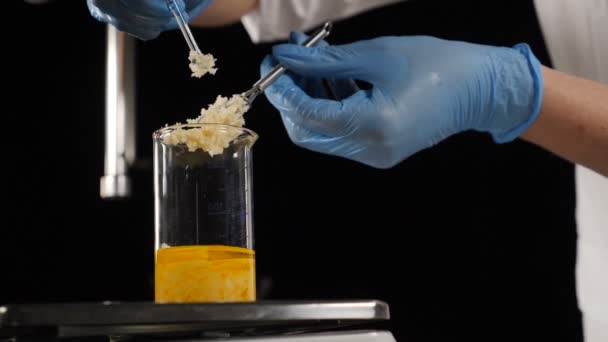 Modern lab concept. Cosmetics manufacture industry. Laboratory assistant mixing ingredients in glass bottle pouring liquid component for body care lotion, cream or shampoo. Slow motion. Full hd — Stock Video