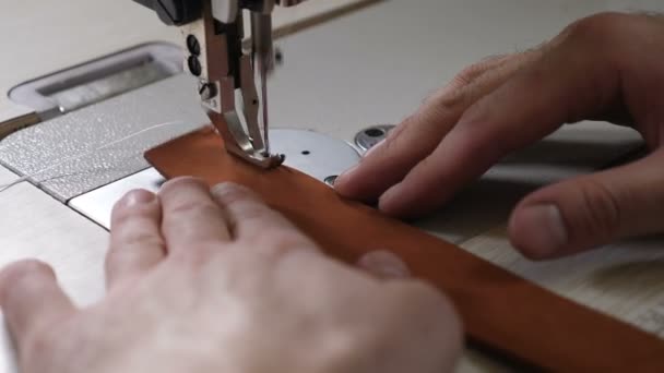 Close-up macro view of sewing machine in leather manufacture, sew leather for belt, bag or wallet. workshop by handmade artisan expert in manufacturing leather belts, manufacture. traditional — Stock Video