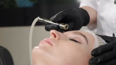 Beautiful woman getting cosmetology procedure in beauty salon. Hardware cosmetology. Anti-aging and anti-wrinkle apparatus cosmetology. Modern relaxing treatment. 4 k footage