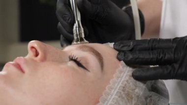 Beautiful woman getting cosmetology procedure in beauty salon. Hardware cosmetology. Anti-aging and anti-wrinkle apparatus cosmetology. Modern relaxing treatment. 4 k footage