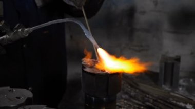 Factory and Industrial concept, Metallurgy. Welding equipment. Yellow flame melting metal in Slow motion. Merge structure of details close-up. Full hd
